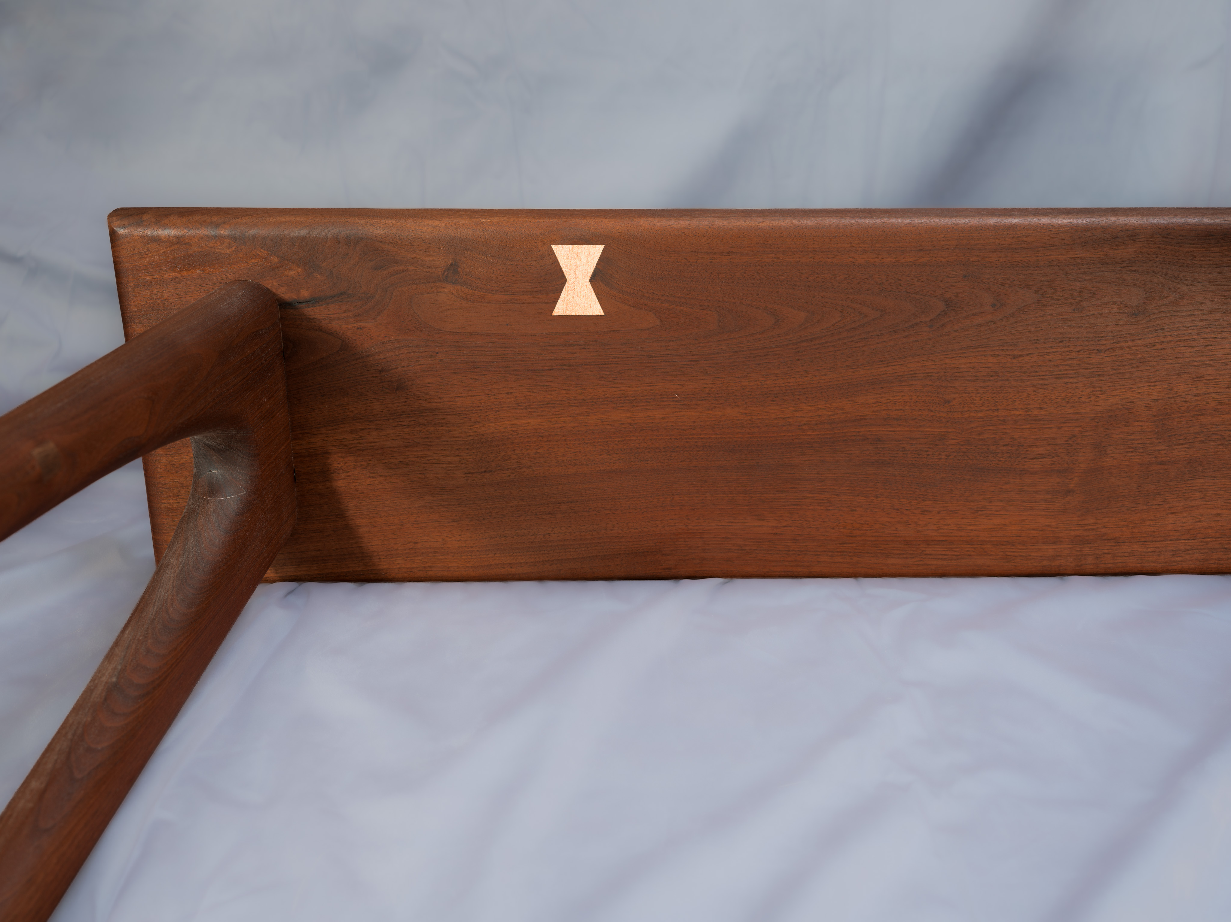 There was a knot on the bottom. Rather than fill in with epoxy, I decided to try a small patch in a wildly different wood. Inspired in some ways by George Nakashima's use of butterflies like this as both a structural and design element.